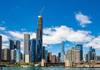 Chicago cityscape, spring day. Chicago city waterfront high rise buildings on the river canal, blue sky background