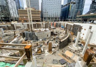 construction-site-surrounded-by-downtown-buildings-2023-11-27-05-15-13-utc-min
